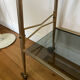 Vintage brass and smoked glass dessert trolley on wheels.