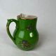 Green milk jug with enamelled flowers