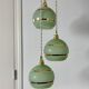 Suspension triple vintage glass globes in frosted green and gold.