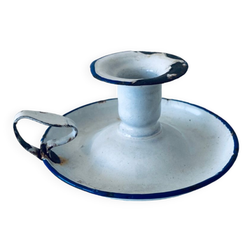 Old candle holder in white enameled metal