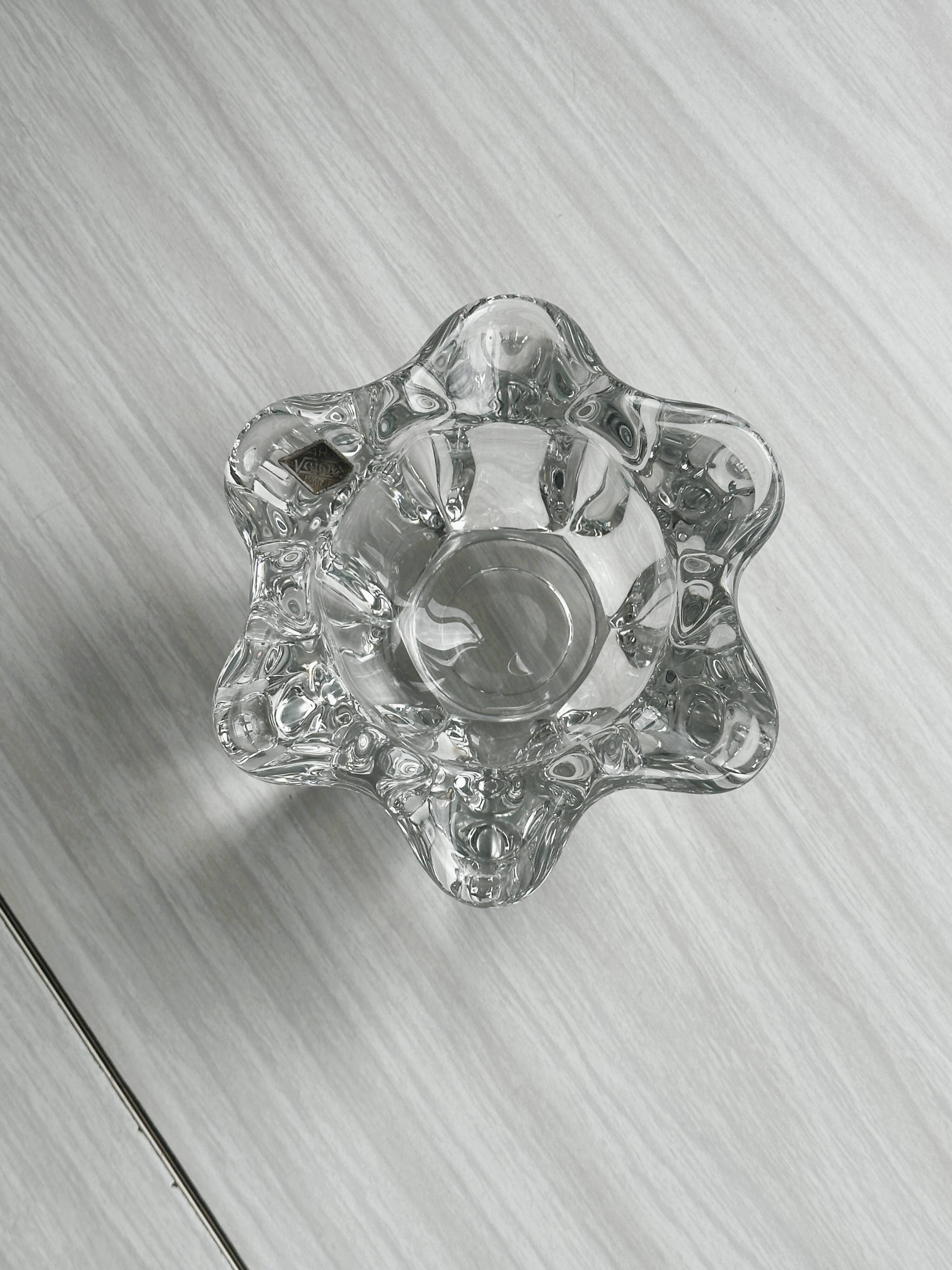 Empty pocket ashtray in transparent crystal organic shape.
