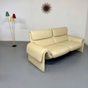 Two-seater designer sofa De Sede DS-2011 in cream leather with adjustable backrest.