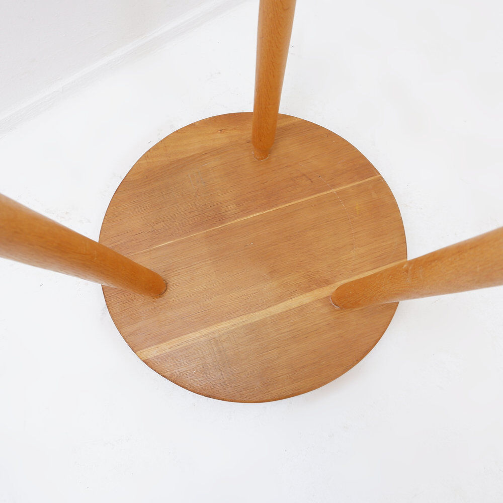 Vintage solid wood side table with rounded legs.