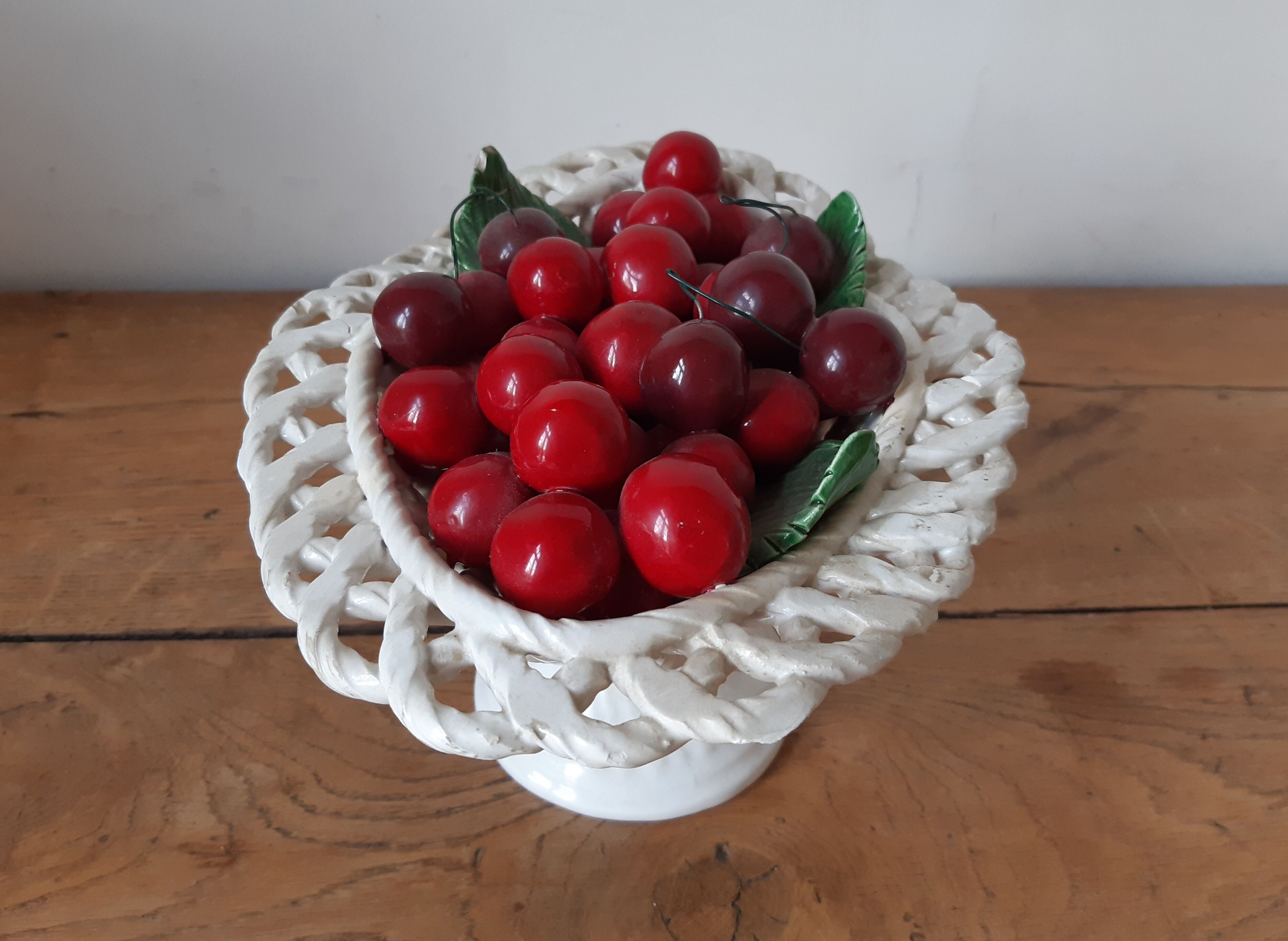 Braided basket of porcelain cherries, Bassano vintage 60s