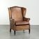 Sheepskin wingback armchair with patina finished with decorative nails