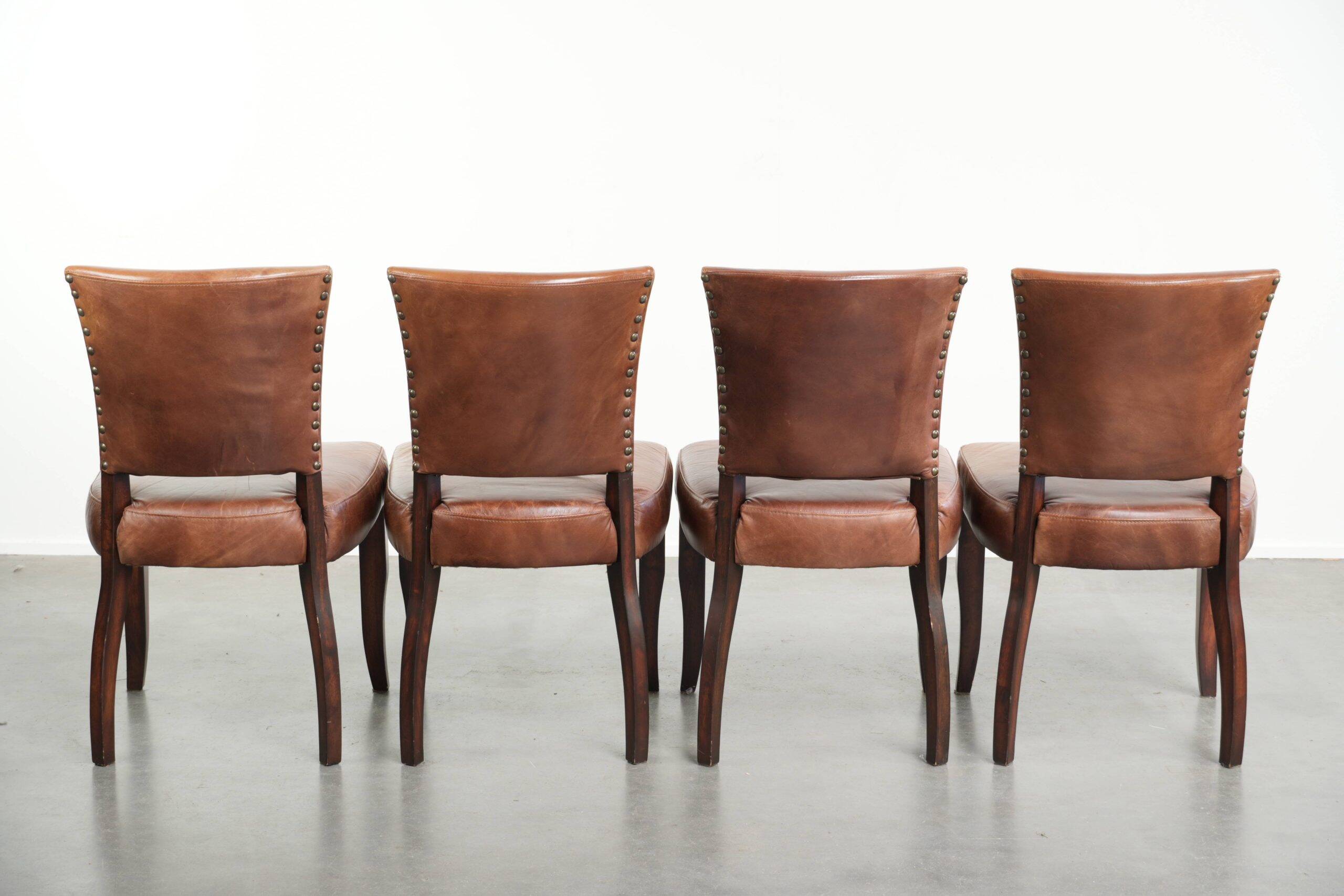 Set of 4 cognac-coloured cowleather dining chairs with decorative nails