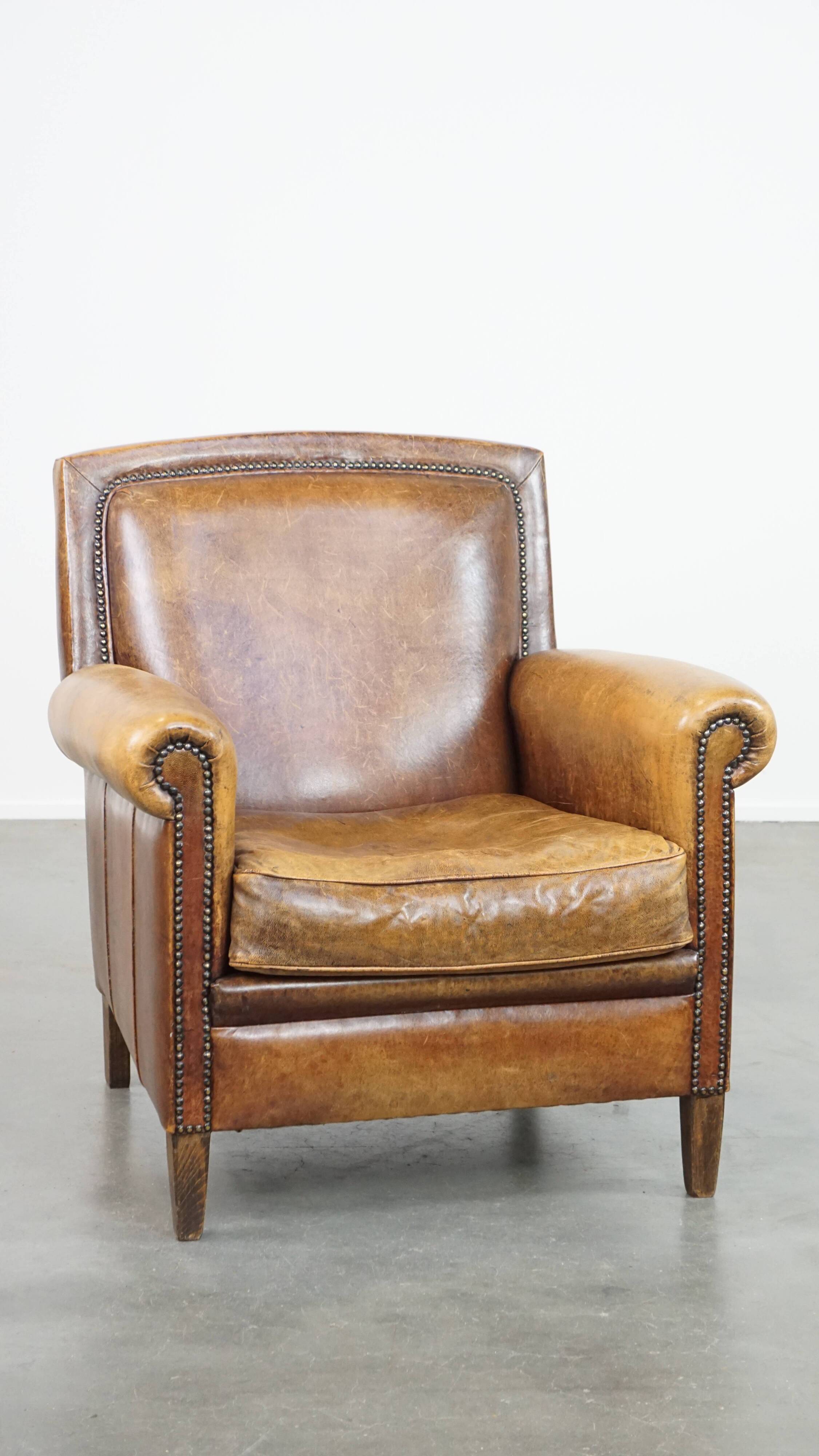 Armchair made of sheep leather finished with decorative nails