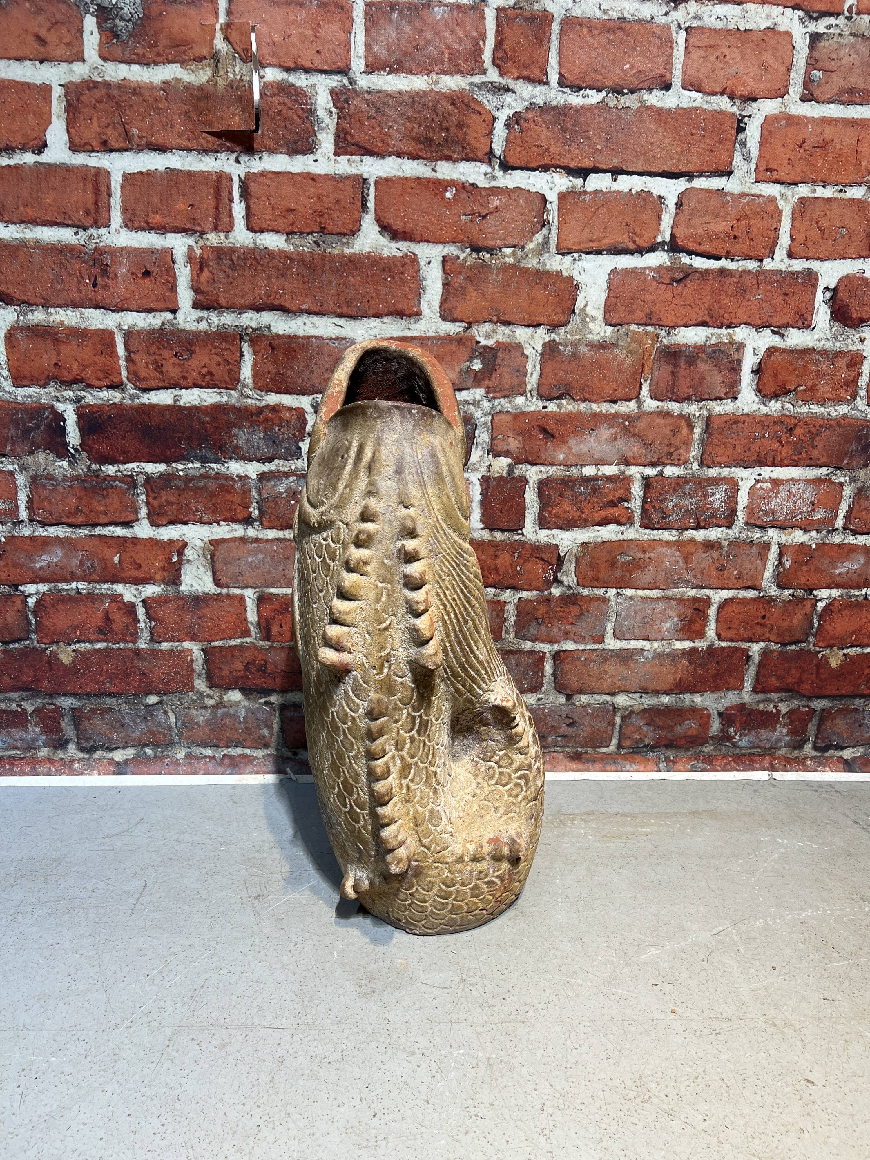 Terracotta umbrella stand in the shape of a fish