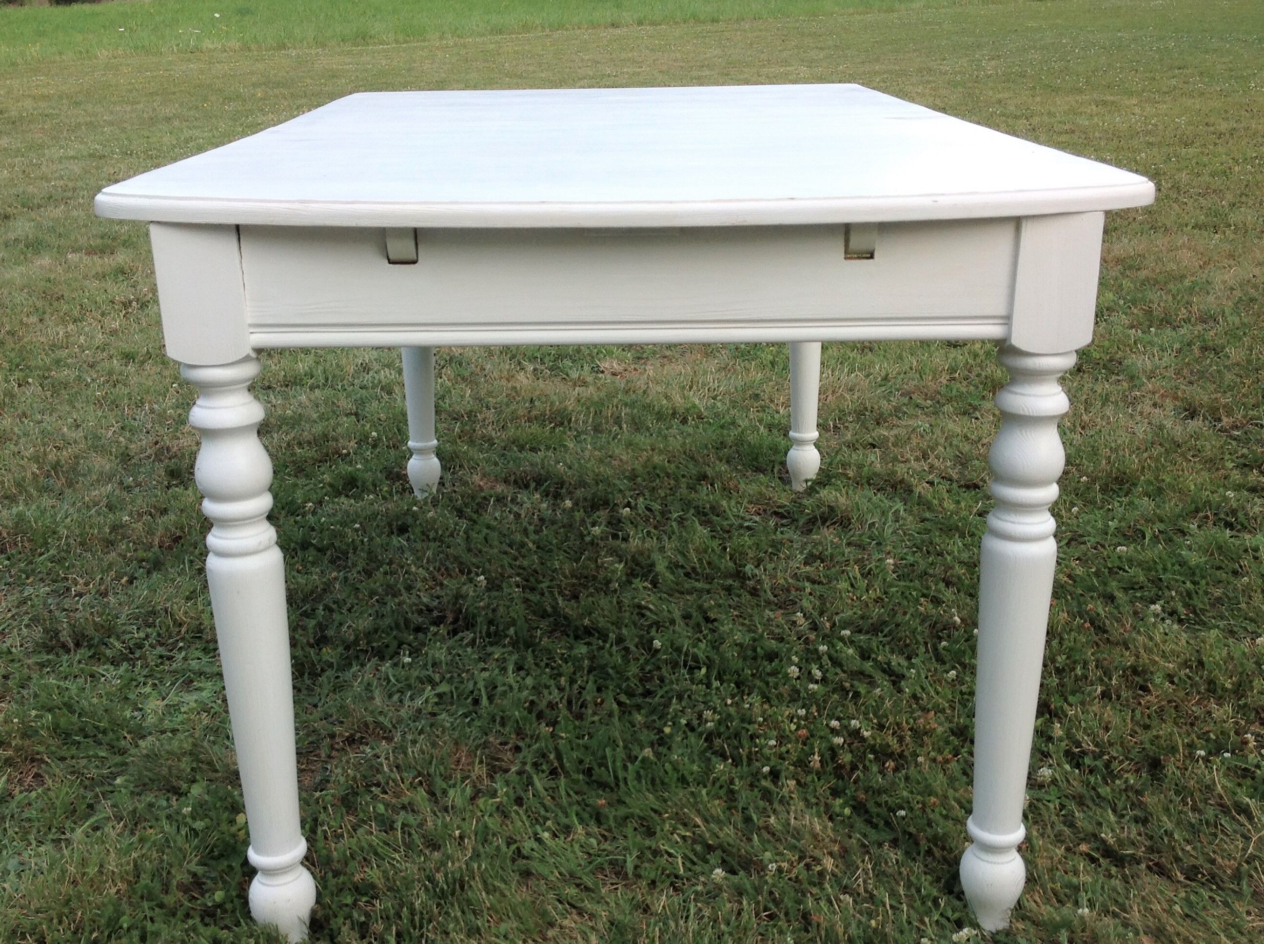 White farmhouse table set and four chairs