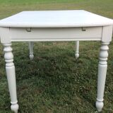 White farmhouse table set and four chairs