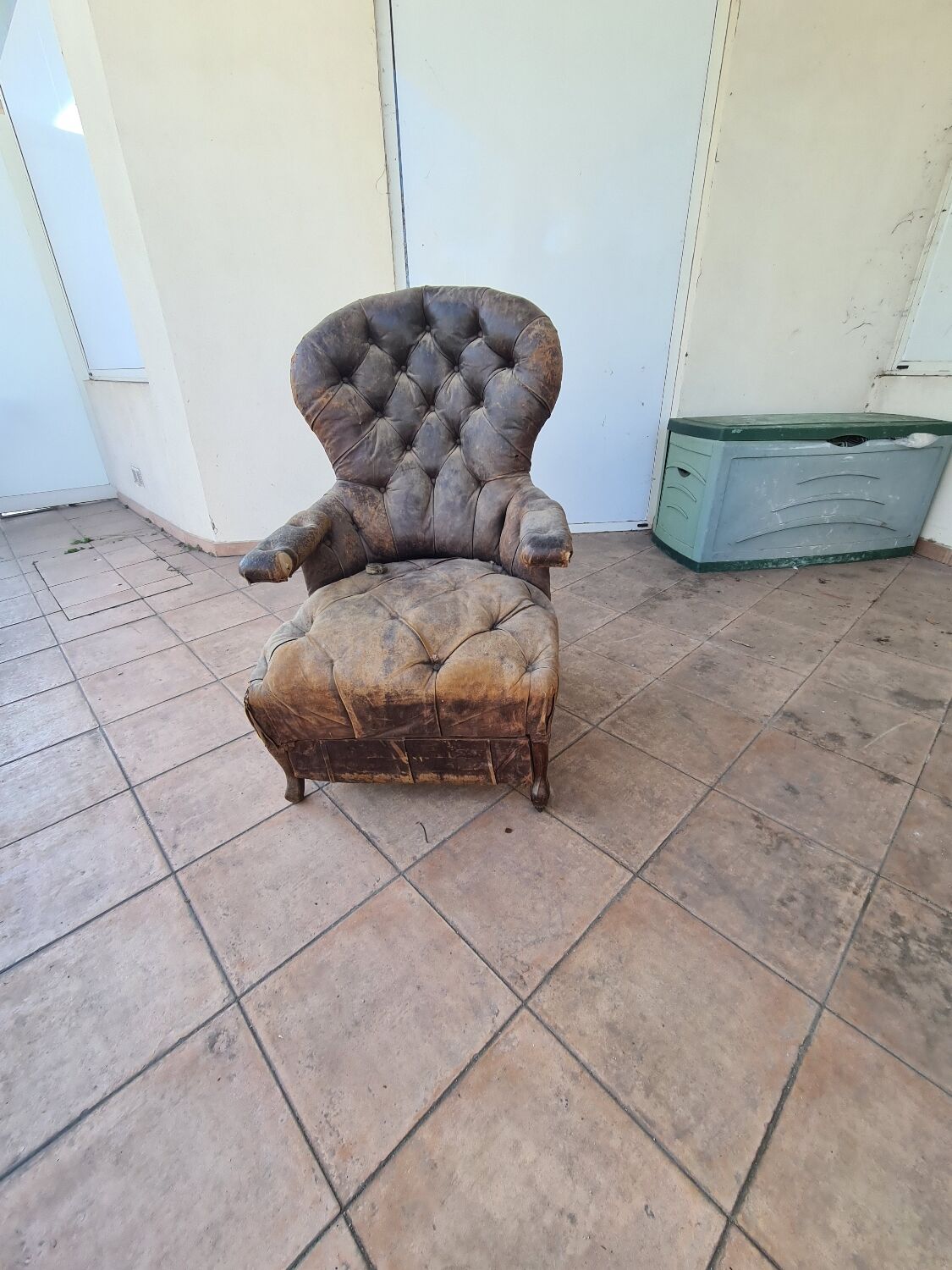 Chesterfield armchair with folding footrest