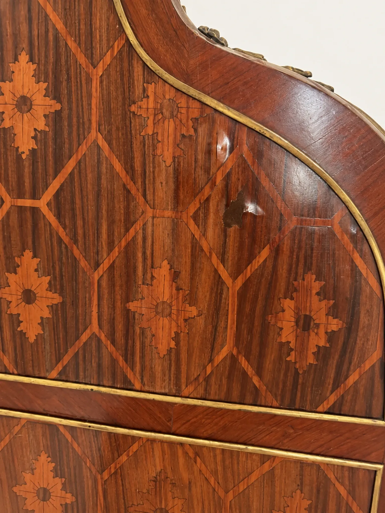Louis XV cylinder desk with floral marquetry and gilded ornaments.