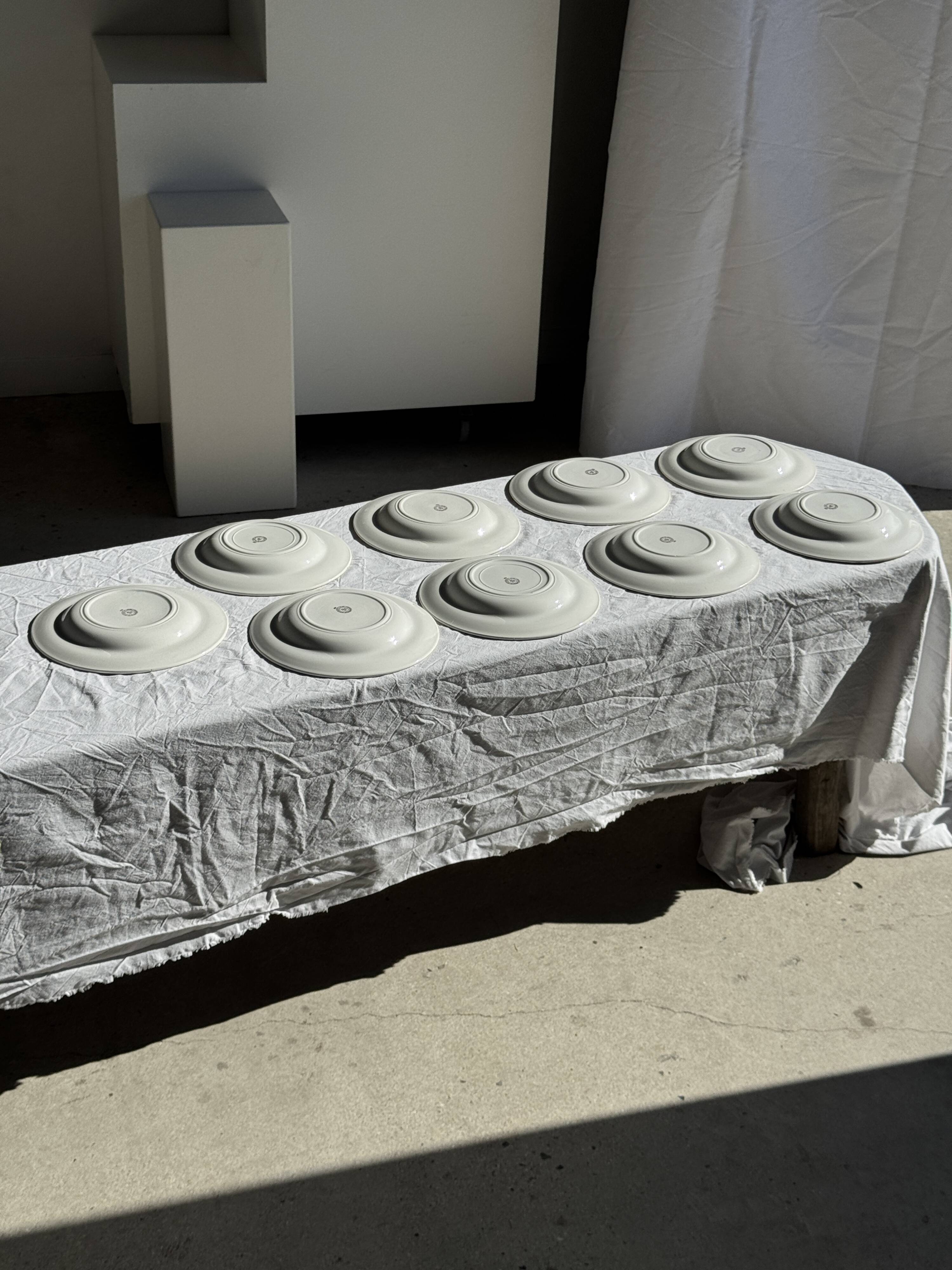 Set of 9 vintage turquoise deep plates with gold trim and pink flowers.