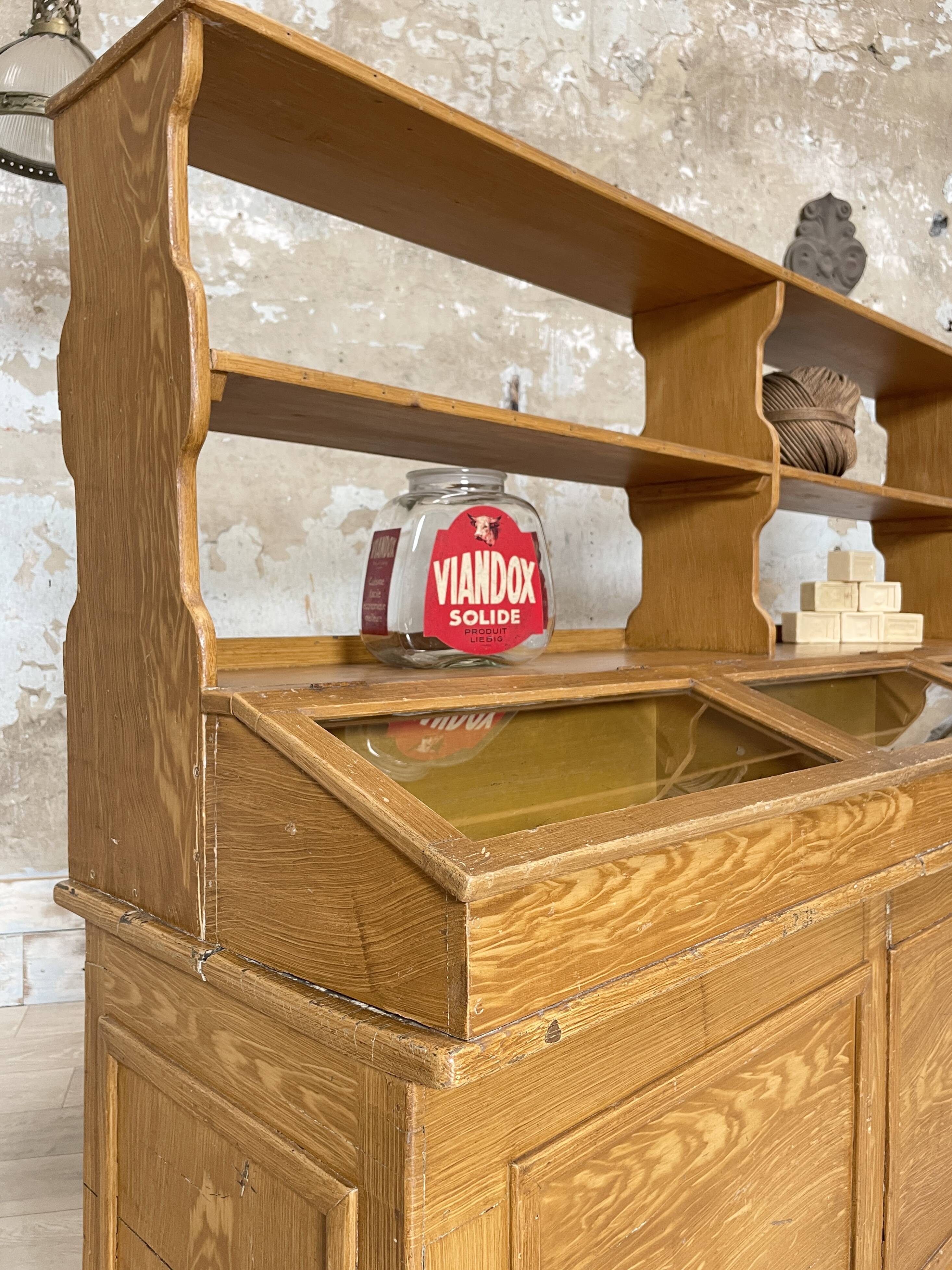 Wooden hardware cabinet painted with wood effect, circa 1940.