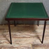 a wooden Bridge game table resting on four thin, straight legs