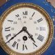 Wall clock in glazed earthenware decoration and brass chain empire style