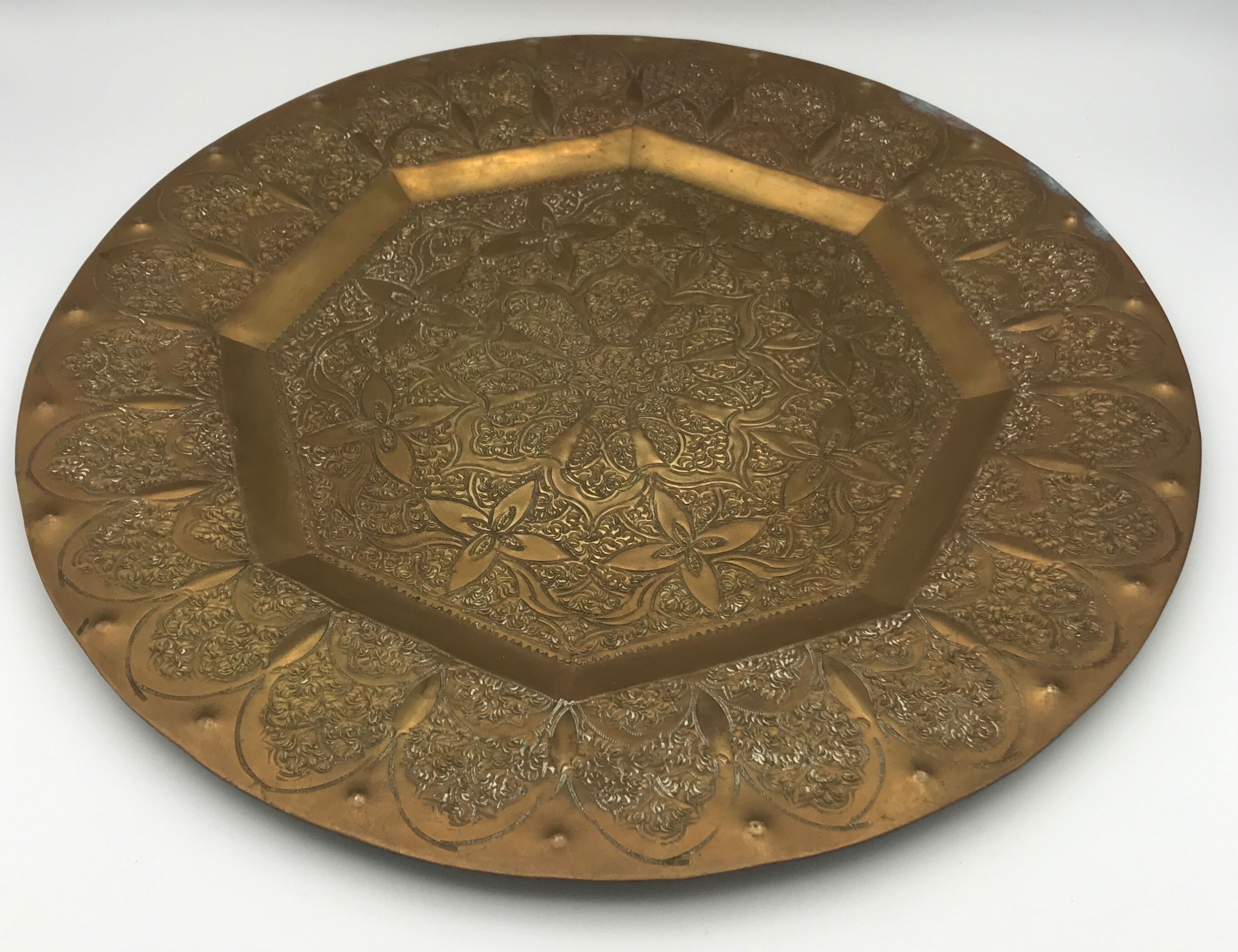 Oriental brass tray with chiseled decoration of arabesques and flowers
