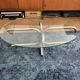Oval glass coffee table with chrome legs, vintage 70s design.