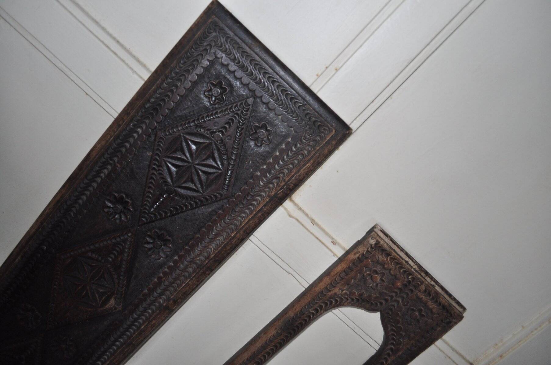 Set of 2 carved brown wooden panels, rural Hungary, 1940s, geometric patterns.