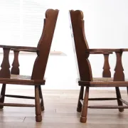 Pair of brutalist oak lounge chairs with rush seats, circa 1935