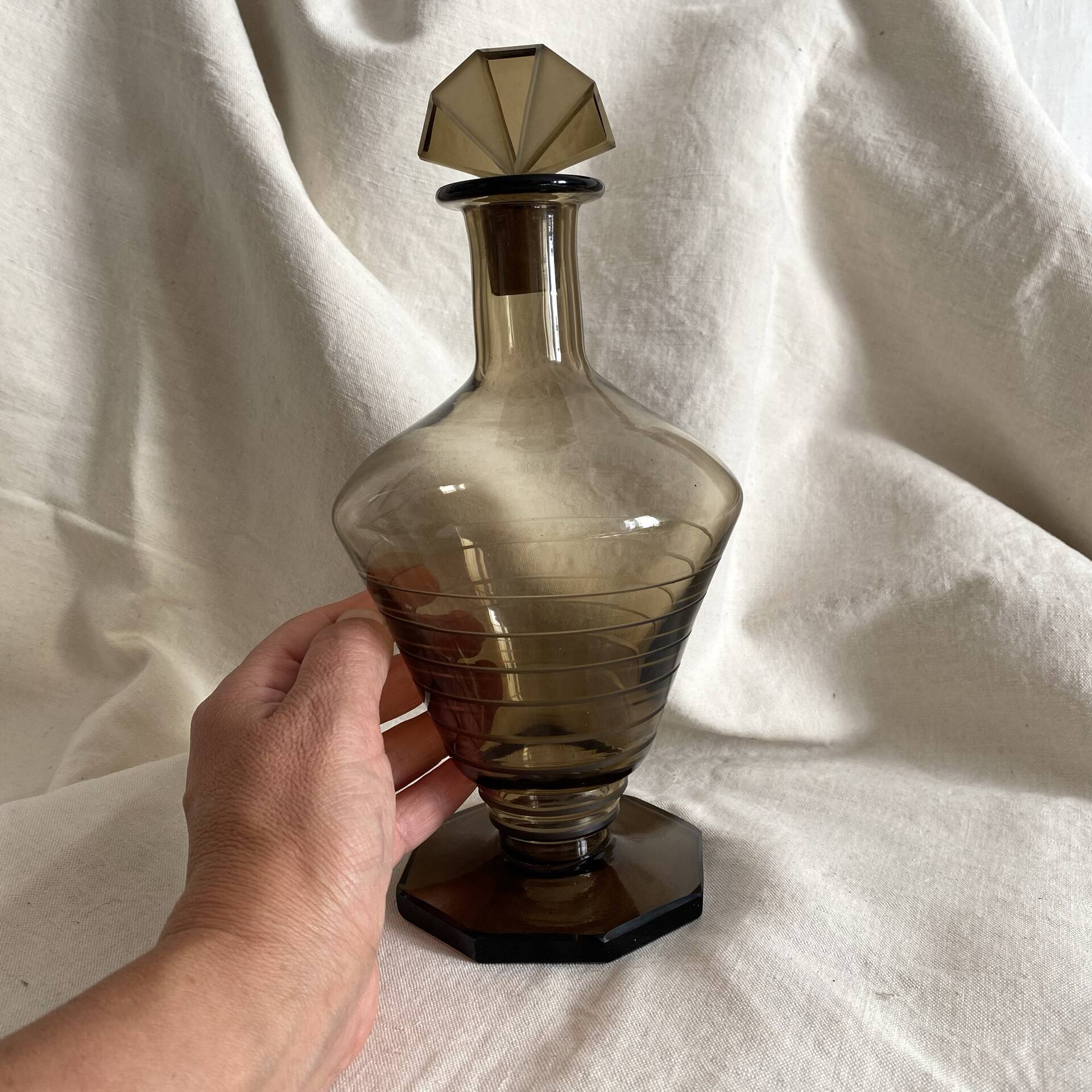 Art Deco smoked glass carafe with fan-shaped stopper.