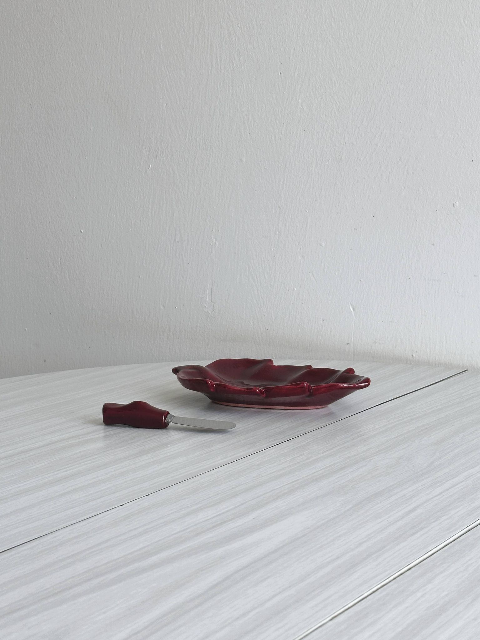 Red ceramic butter dish with knife