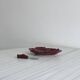 Red ceramic butter dish with knife