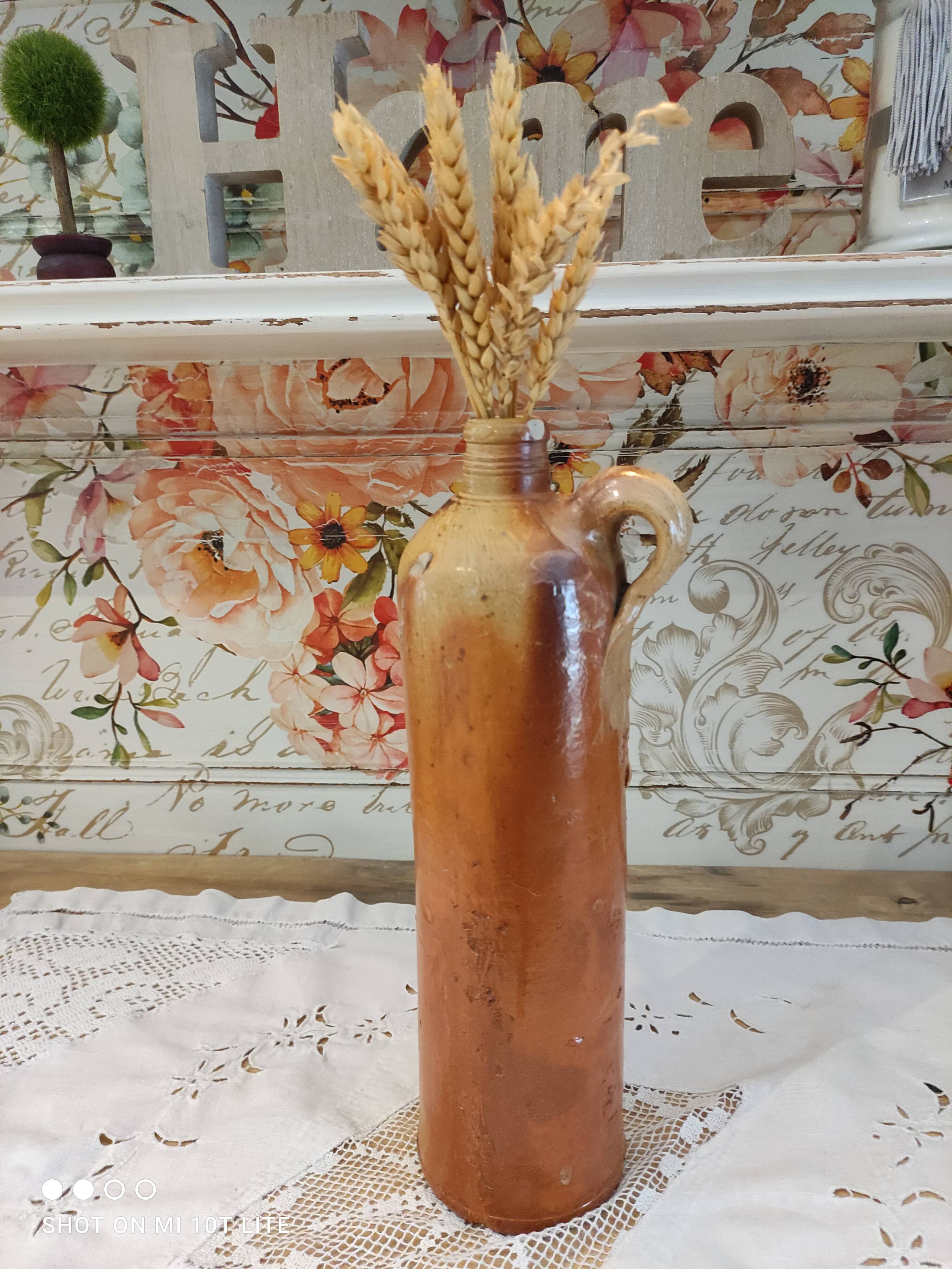 Old bottle in terracotta varnished finish