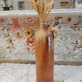 Old bottle in terracotta varnished finish