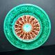 Antique plate in turquoise brown green slip with arabesque decoration