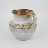 Glazed ceramic jug with plant decoration
