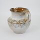 Glazed ceramic jug with plant decoration