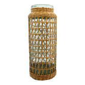 Glass jar like a bottle with woven wicker