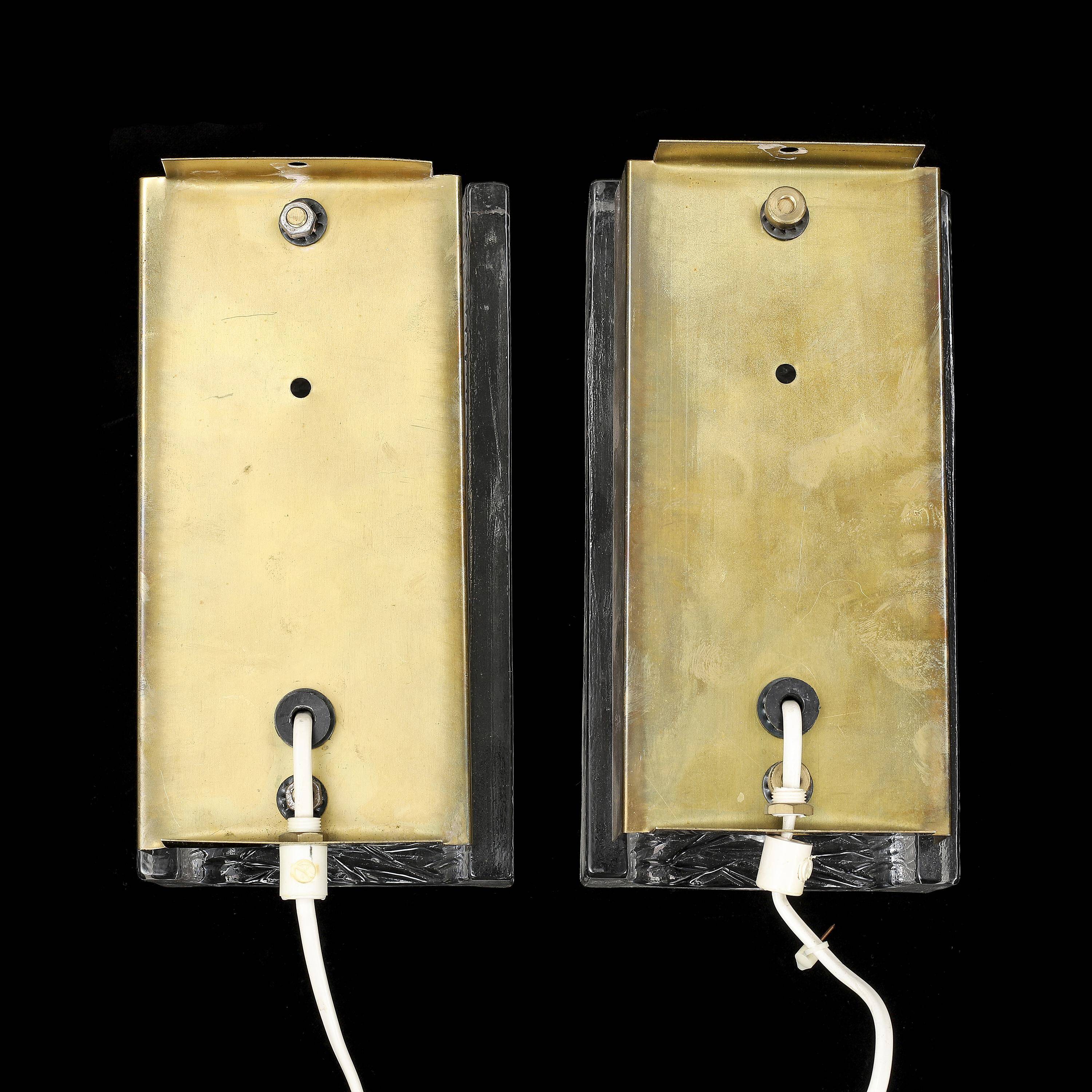 Pair of Orrefors wall lights in cast glass and brass, Sweden 1960.