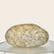 A lamp in the shape of a pebble.