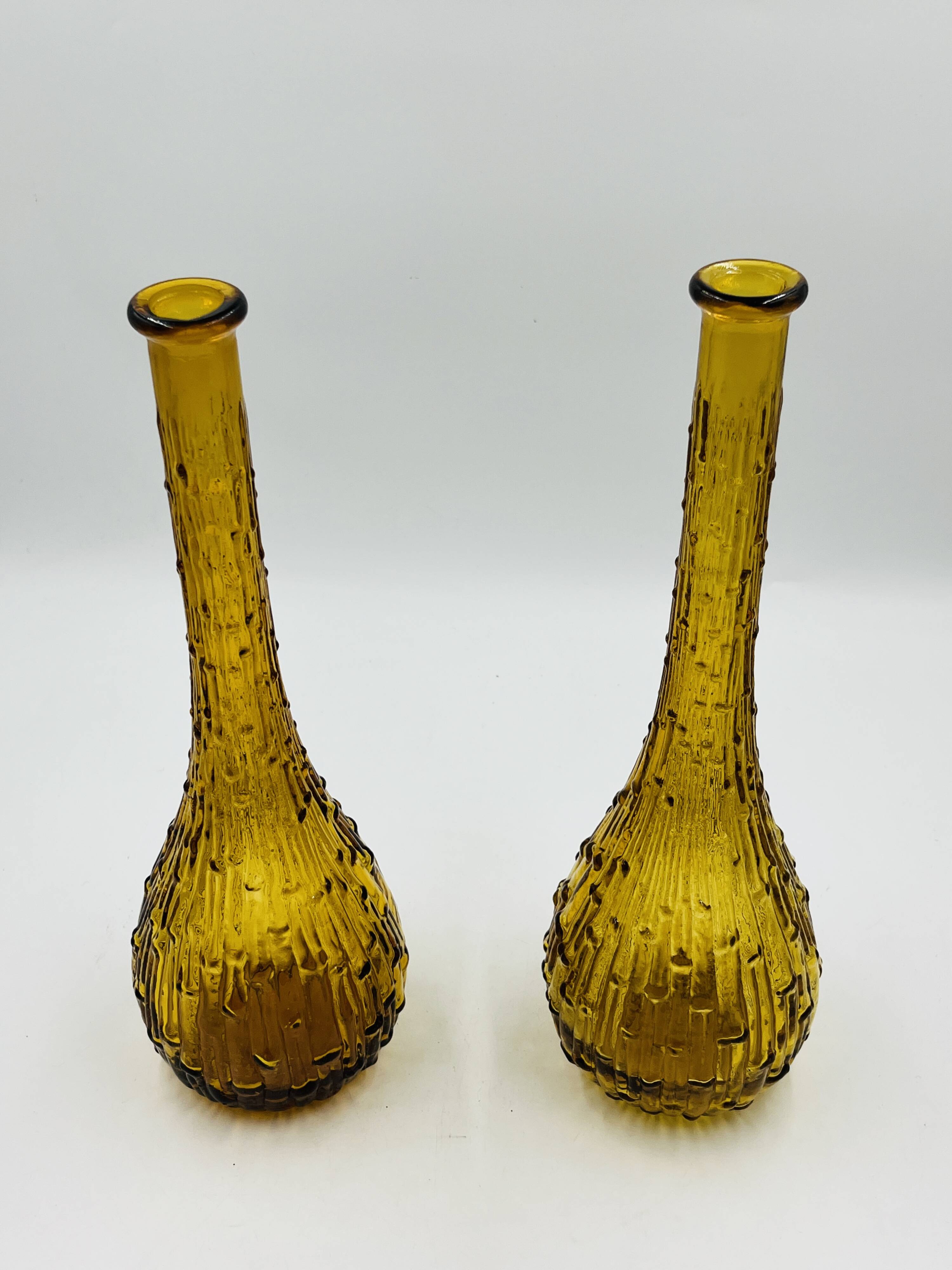 Set of two vintage textured amber glass Empoli bottles.