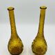 Set of two vintage textured amber glass Empoli bottles.