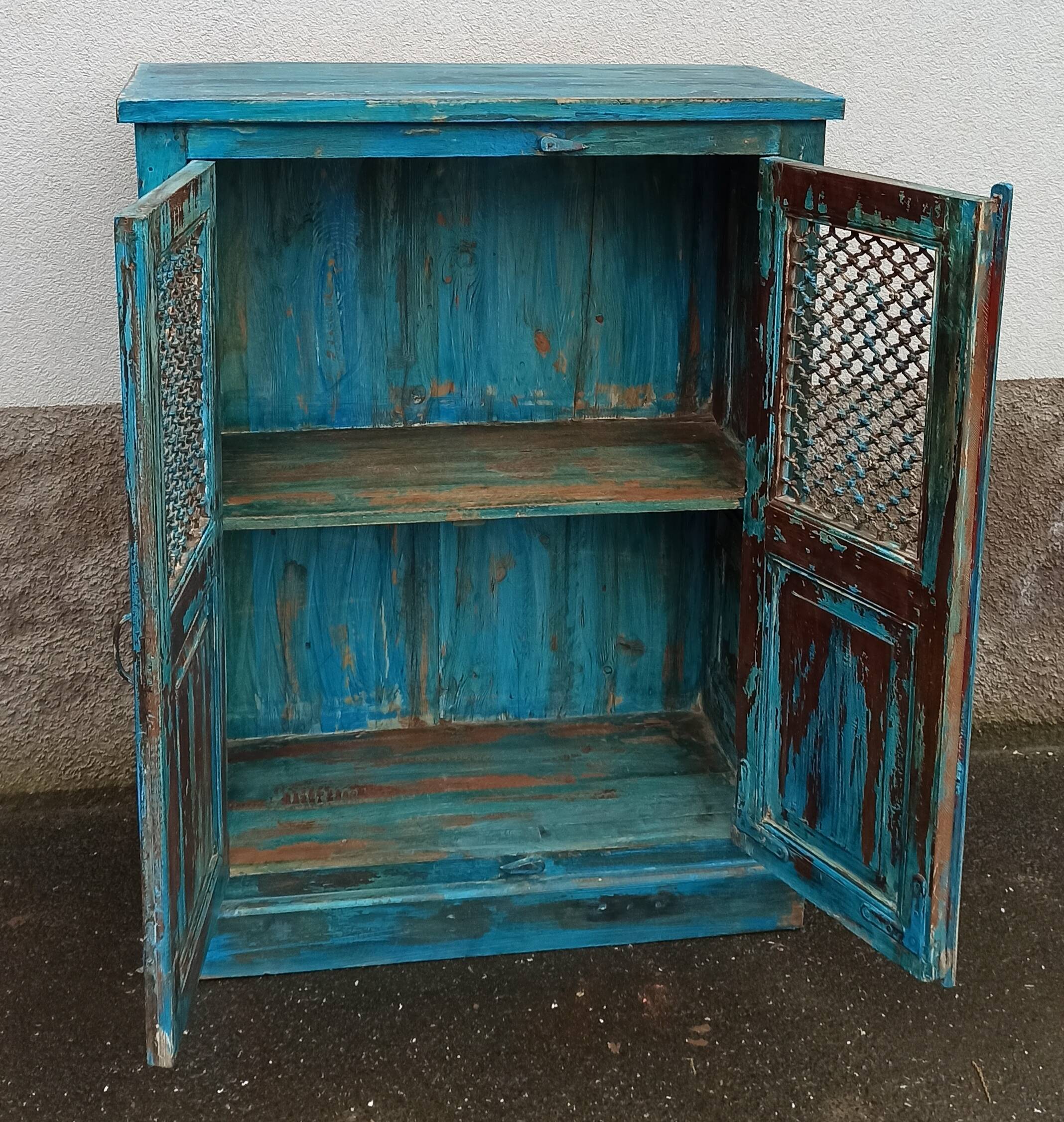 Old wooden cabinet with doors with grille