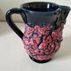 Vintage pitcher in midnight blue glazed ceramic with bright pink relief