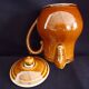 Old covered milk jug, side handle