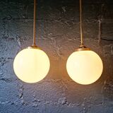 Pair of Art Deco pendant lights in brass and white opaline, 1920-30