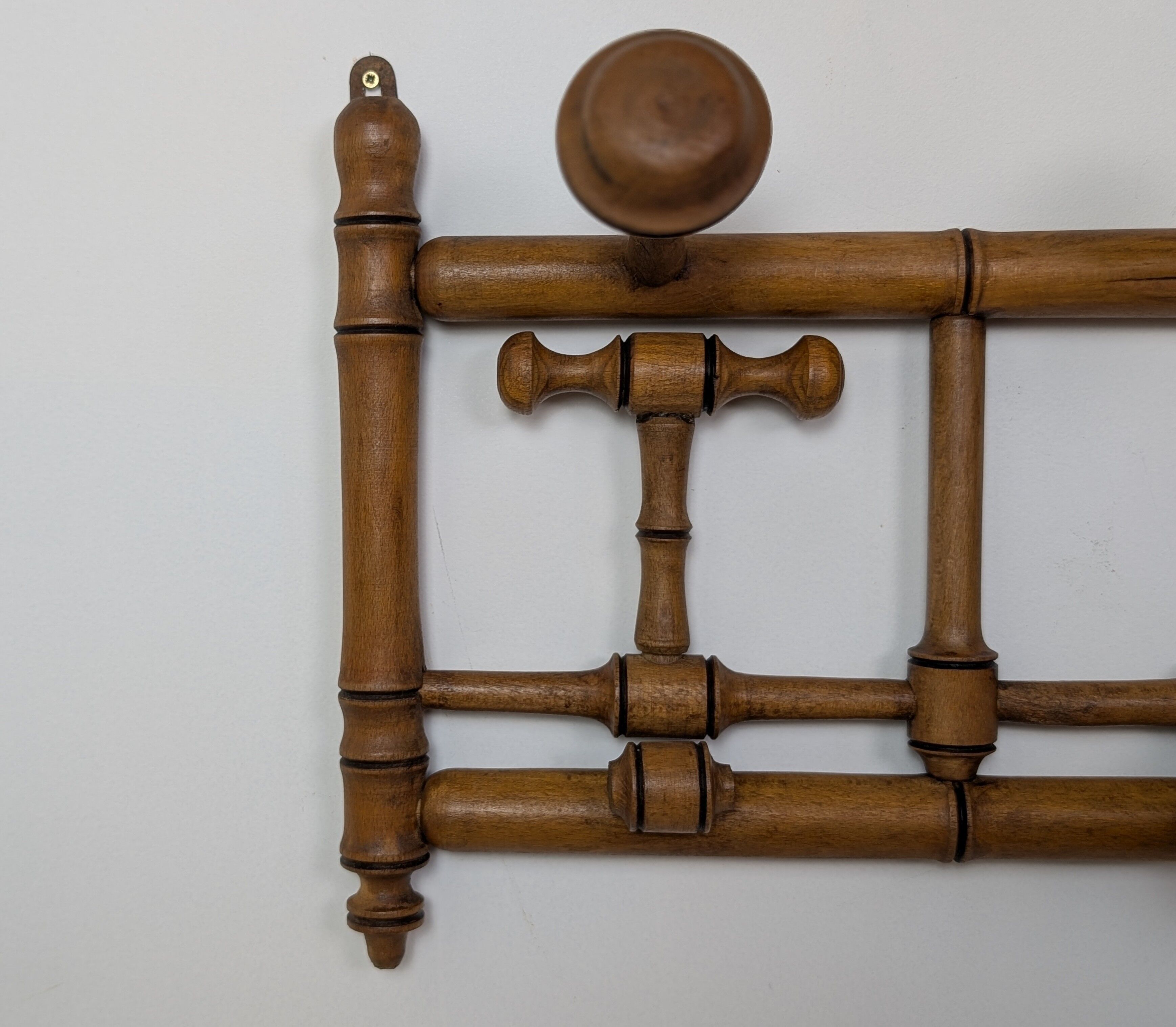Wall-mounted coat rack made of turned wood
