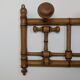 Wall-mounted coat rack made of turned wood
