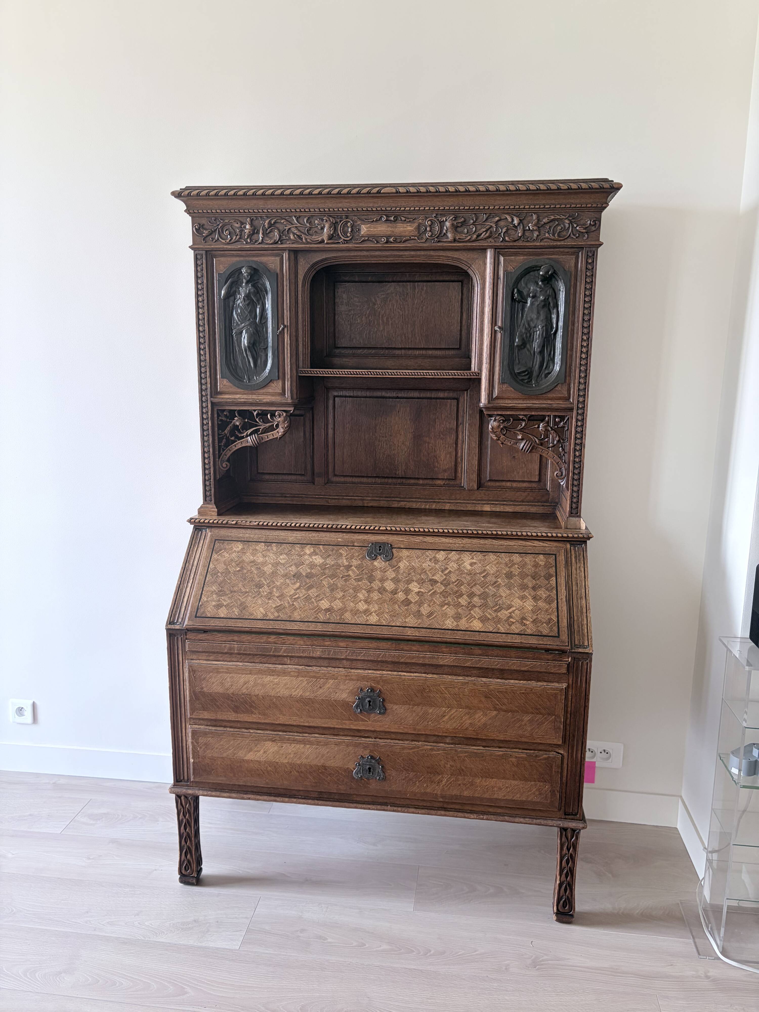 Large secretary with a drop-down front in carved oak, neo-Renaissance style.