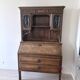 Large secretary with a drop-down front in carved oak, neo-Renaissance style.