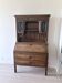 Large secretary with a drop-down front in carved oak, neo-Renaissance style.