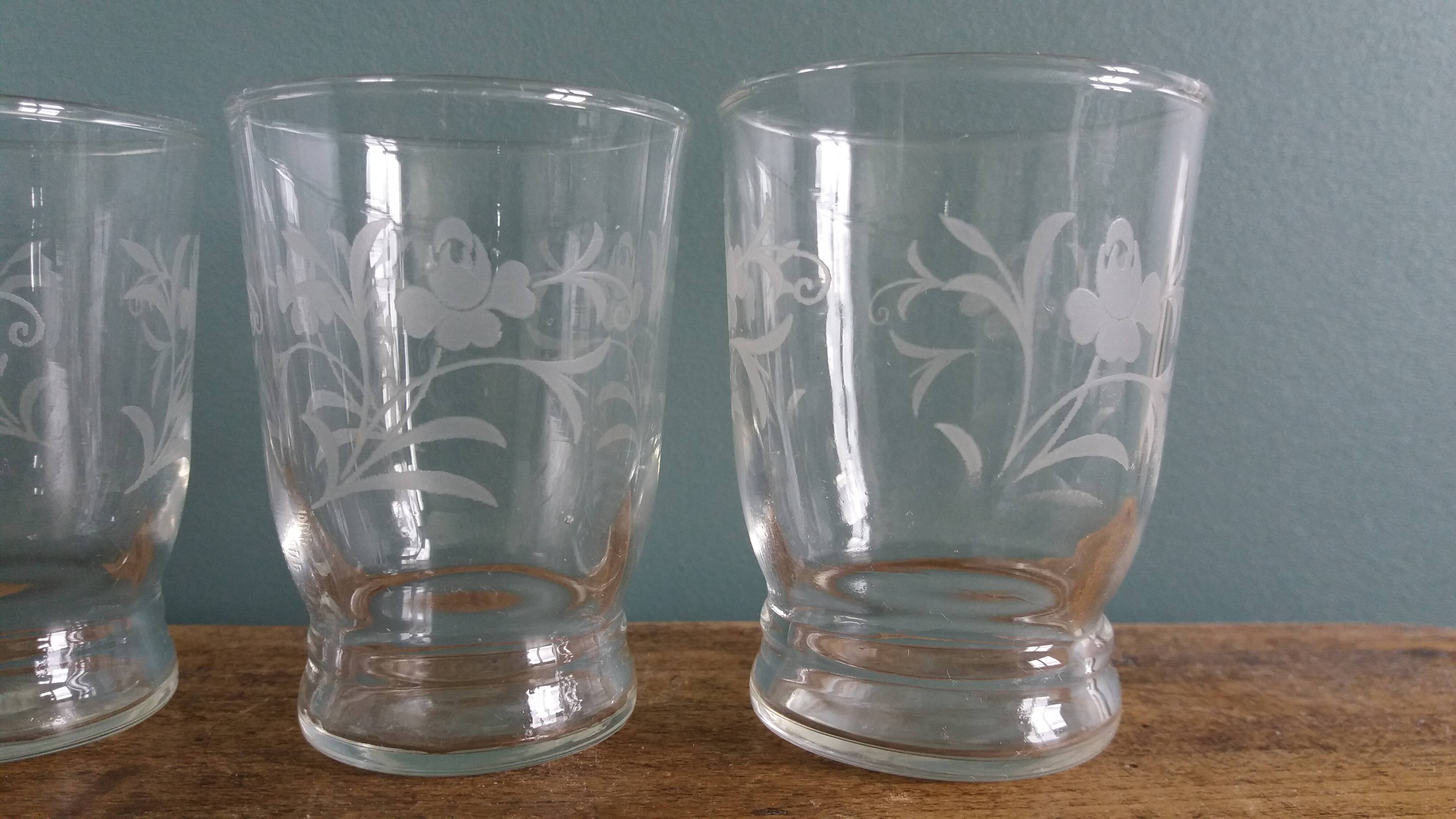 Old digestif or liqueur glasses, handcrafted glass with a floral pattern.