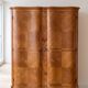 Antique Louis XV style wardrobe with curved wooden doors.