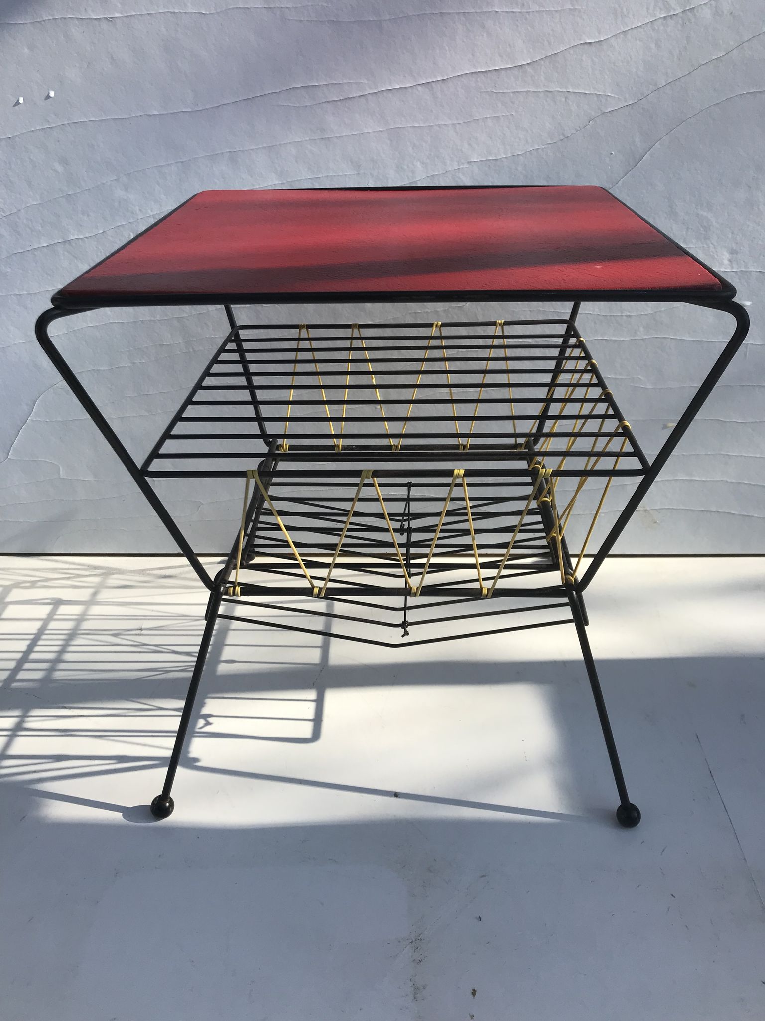 Old coffee table with black metal and scoubidou magazines holder