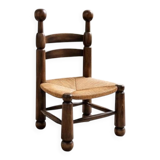 Low fireplace chair in the style of Charles Dudouyt – wood and straw seat.
